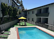 Thumbnail 8 of 30 - A swimming pool is located on the side of a building.