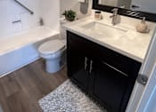 Thumbnail 42 of 45 - a bathroom with a sink and a toilet and a bath tub