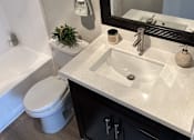 Thumbnail 38 of 45 - a bathroom with a sink toilet and a mirror