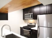Thumbnail 3 of 31 - a kitchen with stainless steel appliances and Expresso Colored cabinets