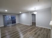 Thumbnail 15 of 31 - an empty living room with wood flooring and a window