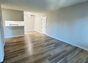 Thumbnail 35 of 36 - A room with a wooden floor and white walls.
