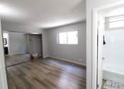 Thumbnail 9 of 31 - an empty living room and a bathroom with a shower and a bath tub