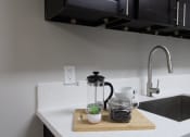 Thumbnail 5 of 31 - a kitchen sink with a coffee maker on a cutting board