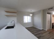 Thumbnail 21 of 45 - a kitchen and living room with a sink and a window