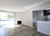 Thumbnail 22 of 45 - an empty living room with wood floors and a fireplace