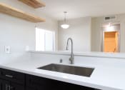 Thumbnail 7 of 45 - an empty kitchen with a sink and a faucet