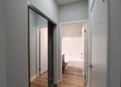 Thumbnail 23 of 45 - a view of the bathroom from the hallway with a door to the closet
