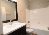 Thumbnail 4 of 45 - an apartment bathroom with a sink toilet and a bath tub