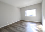 Thumbnail 11 of 45 - an empty room with wooden floors and a window
