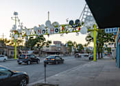 Thumbnail 29 of 30 - A street scene with cars and a sign that says "NO HO".