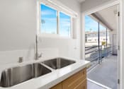 Thumbnail 10 of 40 - A modern kitchen with a double sink and a window.