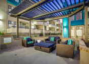Thumbnail 49 of 54 - a patio with couches and a table in front of a building