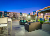 Thumbnail 52 of 54 - a furnished patio with chairs and tables at night