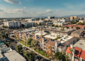 Thumbnail 28 of 30 - A cityscape with buildings and cars.
