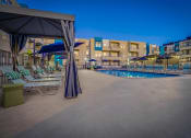 Thumbnail 47 of 54 - a resort pool with chairs and umbrellas at night