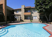 Thumbnail 18 of 37 - A swimming pool in front of a building with a red border.