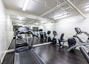 Thumbnail 30 of 37 - A gym with treadmills, exercise bikes, and other equipment.