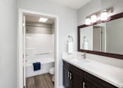 Thumbnail 3 of 37 - A bathroom with a white sink and a white toilet.