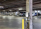 Thumbnail 23 of 37 - A parking garage with a charging station for electric vehicles.