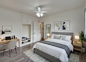 Thumbnail 6 of 49 - A bedroom with a bed, desk, and chair.