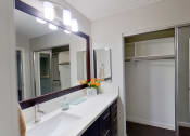 Thumbnail 6 of 18 - a bathroom with a sink and a mirror and a shower
