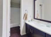Thumbnail 10 of 18 - a bathroom with a sink and a mirror