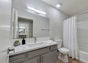 Thumbnail 34 of 34 - A bathroom with a white toilet and a white sink.