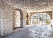 Thumbnail 18 of 31 - A room with arched columns and a tiled floor.