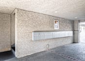 Thumbnail 28 of 31 - A concrete wall with a white electrical box mounted on it.