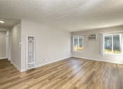 Thumbnail 18 of 40 - A room with wooden flooring and white walls.