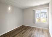 Thumbnail 26 of 40 - A room with wooden flooring and a window.