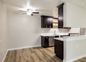 Thumbnail 27 of 40 - A kitchen with a white counter and black cabinets.