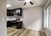 Thumbnail 29 of 40 - A kitchen with a microwave and oven built into the cabinetry.