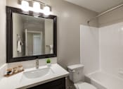 Thumbnail 31 of 40 - A bathroom with a sink, toilet, and bathtub.