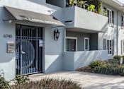 Thumbnail 36 of 40 - A white building with a black gate and a sign that reads "LEASING OFFICE".