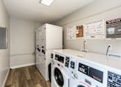 Thumbnail 35 of 40 - A laundry room with a washer and dryer.