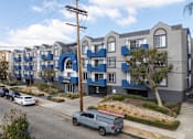 Thumbnail 24 of 31 - A row of modern townhouses with blue trim and balconies.