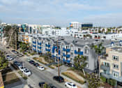 Thumbnail 25 of 31 - A street view of a residential area with cars parked on the side of the road.