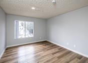 Thumbnail 26 of 31 - A room with wooden flooring and a window.