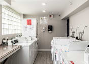 Thumbnail 30 of 31 - A laundry room with washers and dryers.