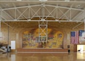 Thumbnail 3 of 16 - A large room with a mural on the wall and an American flag.