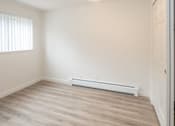 Thumbnail 7 of 9 - A room with a window and a radiator on the wall.