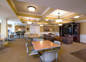 Thumbnail 9 of 18 - A large room with a long table and chairs.