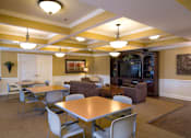 Thumbnail 10 of 18 - A living room with a dining table and chairs.