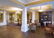 Thumbnail 14 of 18 - A large room with a long table and chairs.