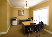 Thumbnail 17 of 18 - A room with a desk and chairs.