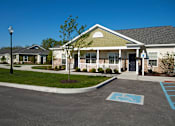 Thumbnail 4 of 18 - A parking lot with a handicap parking space in front of a building.