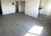 Thumbnail 8 of 23 - A room with a grey carpet and a white wall with a light switch.