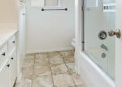 Thumbnail 11 of 12 - Full bath and shower featuring towel rod and cabinetry
